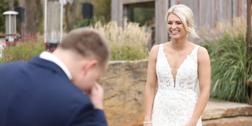 Emotional groom seeing bride in her dress for the first time