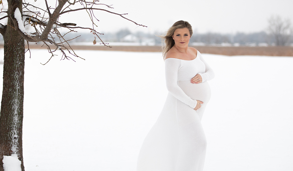 Two expectant mothers having photos taken in the snow